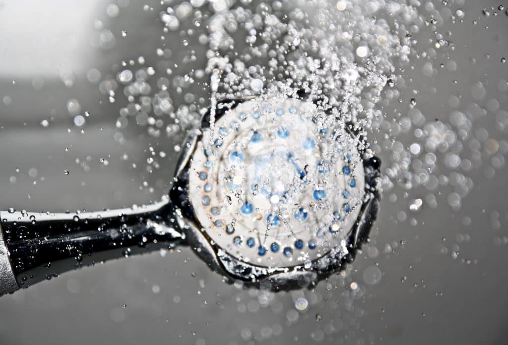 bottom view of a shower head spraying water