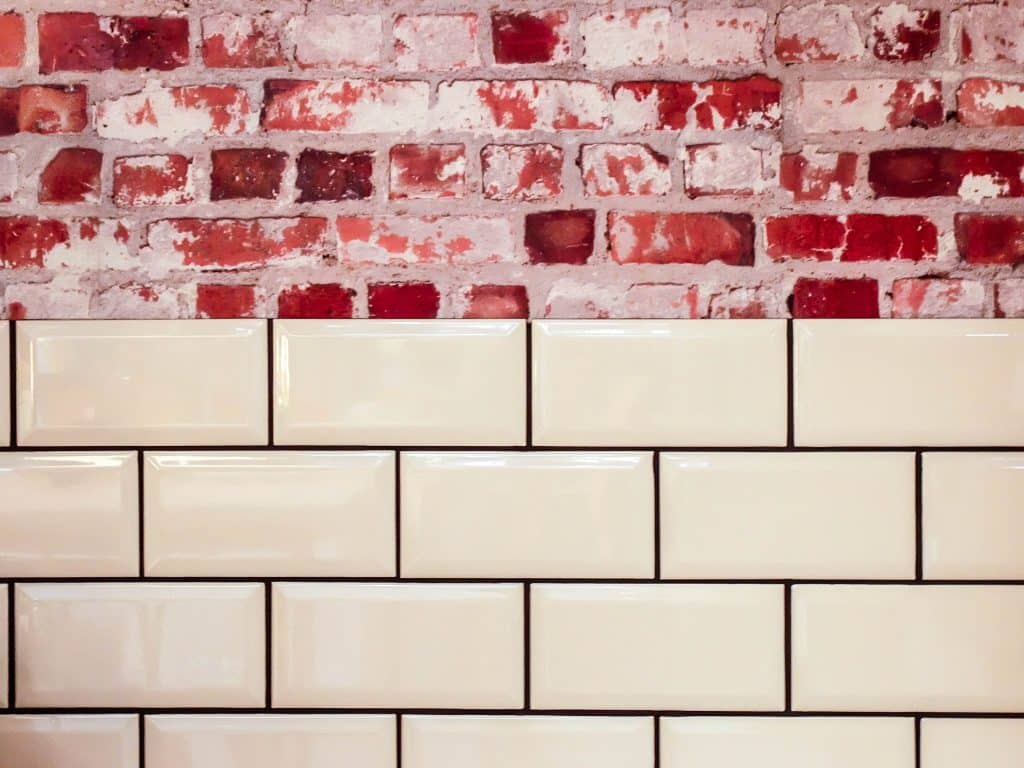 red bricks covered half by white tiles