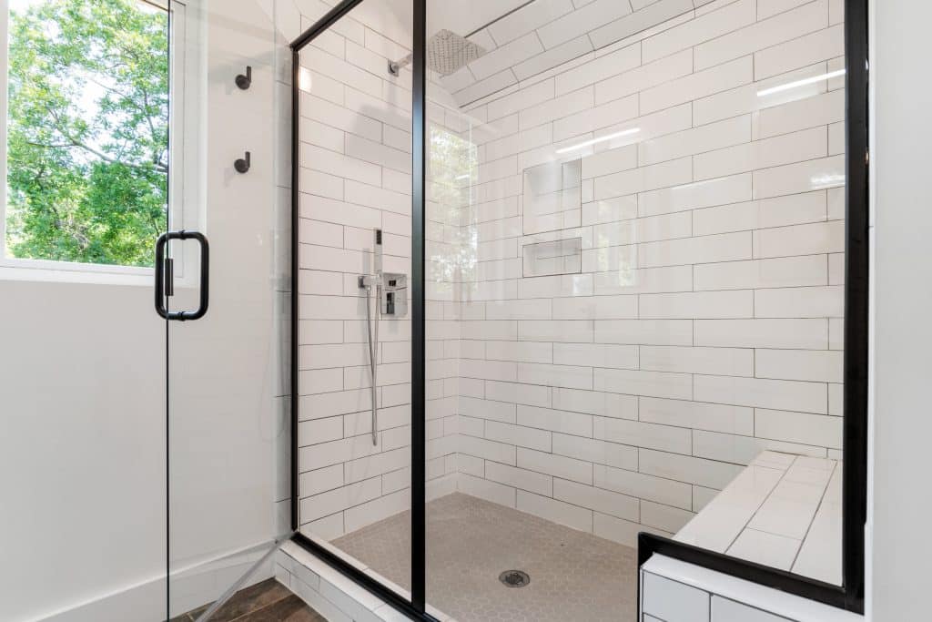 Glass Door in a white tiled Bathroom